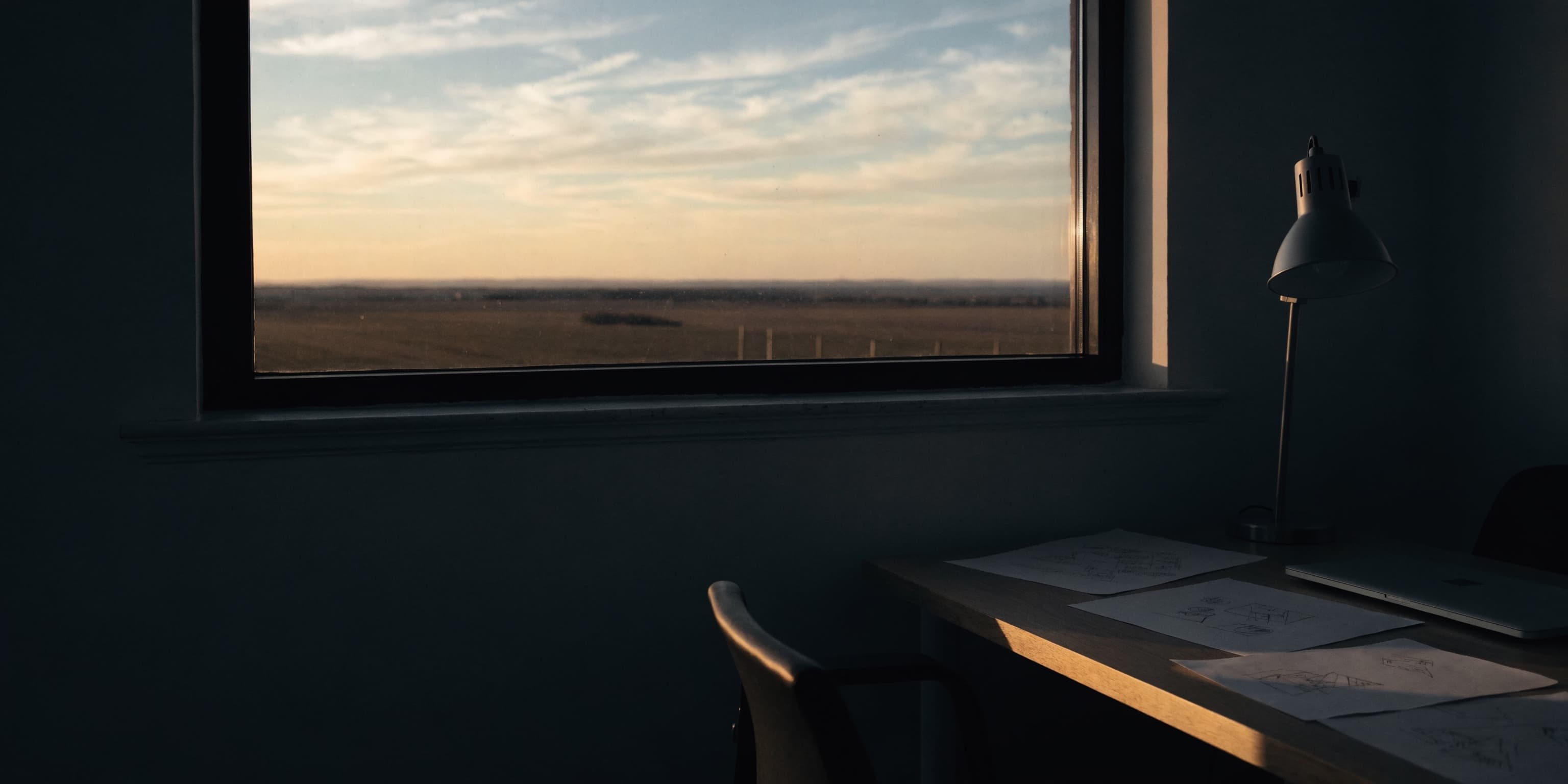 Sunrise through the office window, lamp still on